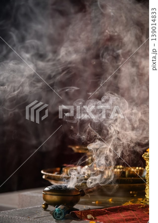 Mystic Smoke Rising from a Traditional Brass Incense Burner for Spiritual Rituals and Meditation Mystic Smoke Rising from a Traditional Brass Incense Burner for Spiritual Rituals and Meditation 139014833