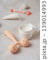 Skincare beauty routine with cosmetic tubes, cream jar and facial massage rollers on marble background, wellness concept 139014993