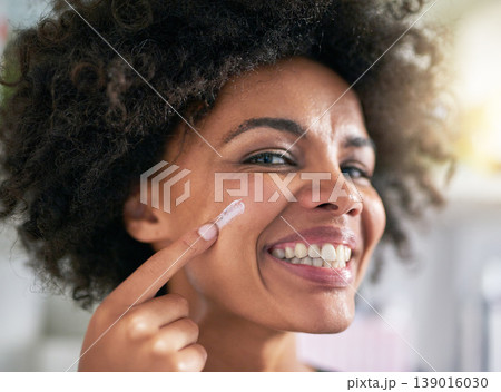 Portrait, woman and hand with moisturiser for skincare, treatment and facial in home. Black person, happy and smile for dermatology, result and hydration with collagen boost, lotion and sunscreen Portrait, woman and hand with moisturiser for skincare, treatment and facial in home. Black person, happy and smile for dermatology, result and hydration with collagen boost, lotion and sunscreen 139016030