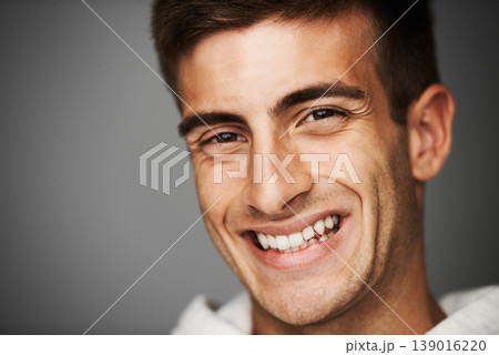 Portrait, smile of man and student in studio isolated on a gray background mockup space. Face, happy young person and model with positive facial expression, excited and cheerful in Spain at college Portrait, smile of man and student in studio isolated on a gray background mockup space. Face, happy young person and model with positive facial expression, excited and cheerful in Spain at college 139016220