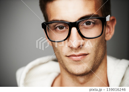 Closeup, portrait and man with glasses in studio for eye care mock up on gray background in Spain. Male model, person and vision with facial expression for spectacles by correction, lens or sight 139016246