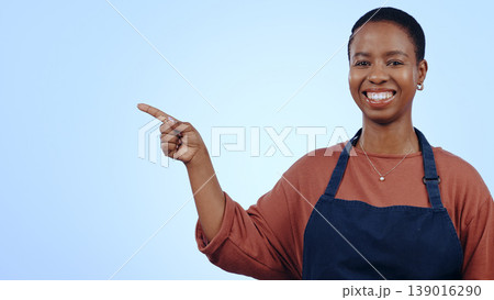 Woman, portrait and pointing for presentation in studio with smile, announcement or advertising space. Black person, face and smile for marketing, showing deal or discount with hand and joy on mockup 139016290