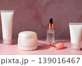 Skincare beauty products set with facial roller, cream jar, serum dropper and cosmetic bottles on pink background, beauty routine concept 139016467