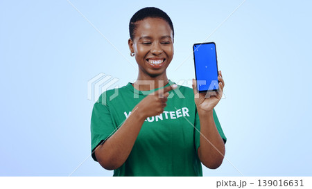 Woman, volunteer and phone green screen, presentation mockup and support, join us or marketing in studio. Happy African person pointing to mobile, information and NGO volunteering on blue background Woman, volunteer and phone green screen, presentation mockup and support, join us or marketing in studio. Happy African person pointing to mobile, information and NGO volunteering on blue background 139016631