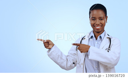 Woman, portrait and pointing for announcement in studio with smile, presentation or advertising space. Doctor, black person and happy for marketing, showing deal or discount with hand and joy mockup Woman, portrait and pointing for announcement in studio with smile, presentation or advertising space. Doctor, black person and happy for marketing, showing deal or discount with hand and joy mockup 139016720