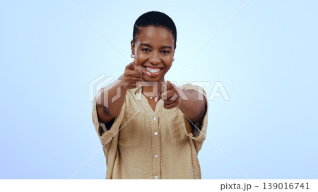 Black woman, portrait and pointing to you in studio for choice, vote for winner and decision to volunteer on blue background. Smile, finger and recruitment for hiring, emoji and invitation to join us Black woman, portrait and pointing to you in studio for choice, vote for winner and decision to volunteer on blue background. Smile, finger and recruitment for hiring, emoji and invitation to join us 139016741