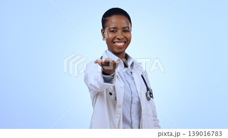 Portrait, black woman and doctor with open palm, promotion and healthcare on a blue studio background. Face, African person and professional with donation, charity and medical with welcome or support 139016783