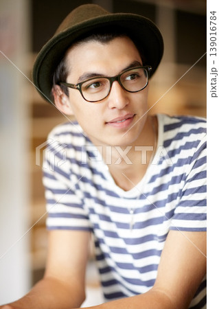 Fashion, thinking and a young hipster man in a glasses for vision or eyesight on a blurred background. Style idea, eyewear and a confident person in a hat as a casual clothing outfit accessory Fashion, thinking and a young hipster man in a glasses for vision or eyesight on a blurred background. Style idea, eyewear and a confident person in a hat as a casual clothing outfit accessory 139016784
