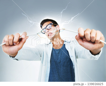 Man, holding and wire for power in studio for electric engineering mockup on gray background. Portrait, male model or technician for cable by fixing, repair and technology for glitch on web in Spain Man, holding and wire for power in studio for electric engineering mockup on gray background. Portrait, male model or technician for cable by fixing, repair and technology for glitch on web in Spain 139016825