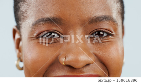 Happy, eyes and portrait of black woman on blue background for confidence, pride and beauty. Cosmetics, closeup and face of African person smile with happiness, makeup and dermatology in studio 139016890