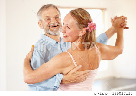 Senior couple, dancing and happiness in home, love and ballroom for fun, touch and romantic. Retirement, bonding together and smile for husband, wife and quality time with tango, retired or elderly 139017110