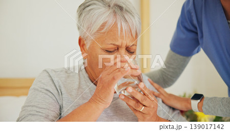 Nurse, senior woman and drinking water for medication in healthcare, support or trust at old age home. Closeup of mature patient with mineral drink, beverage or medical caregiver in natural nutrition 139017142