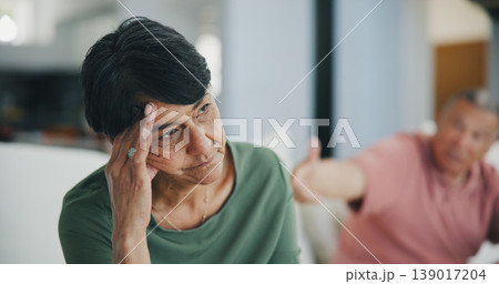 Senior couple, fight and divorce or headache, drama and disagreement on couch. Elderly people, breakup and argument on debt, toxic marriage and gambling problem or stress, mistake and conflict 139017204