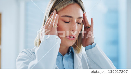Doctor, woman and headache in office with burnout, stress and risk at hospital or clinic from migraine. Person, employee or professional with wellness, anxiety or discomfort from strain at workplace 139017207