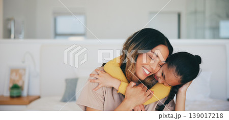 Love, hug and a mother hugging her daughter in the bedroom of their home in the morning together. Face, smile and a happy young girl embracing her single parent while on a bed in their apartment 139017218