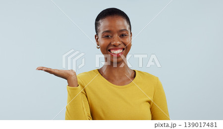 Happy black woman, portrait smile and palm for advertising or marketing against a studio background. Face of African female person sign with hand out showing advertisement or offer on mockup space 139017481