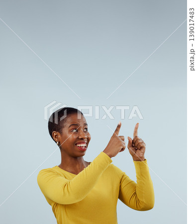 Mockup, smile and black woman with hand pointing up in studio for presentation on grey background. News, announcement and African female model show feedback, checklist or schedule, promo or platform 139017483