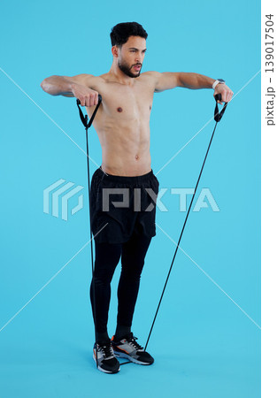 Fitness, stretching rope and man in studio for power workout, body building and building muscle strength. Exercise, sports and athlete on blue background with resistance training, gym and performance Fitness, stretching rope and man in studio for power workout, body building and building muscle strength. Exercise, sports and athlete on blue background with resistance training, gym and performance 139017504