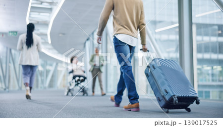 Closeup, walking and man with a suitcase, back and airport to travel, vacation or holiday in airline hallway. Luggage, legs and person on flight terminal, immigration journey or international trip 139017525