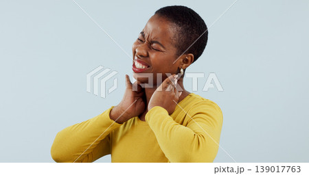 Black woman, neck pain and injury in stress, pressure or anxiety against a gray studio background. Face of frustrated African female person or model with sore joint, inflammation or ache on mockup 139017763