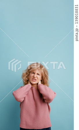 Woman suffering from neck pain, feeling discomfort and distress Woman suffering from neck pain, feeling discomfort and distress 139018831