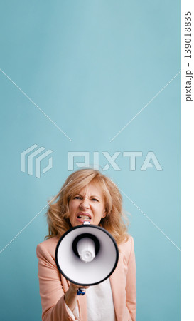 Woman shouting through megaphone expressing protest or demand Woman shouting through megaphone expressing protest or demand 139018835