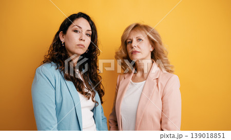 Serious women professionals standing together in studio 139018851
