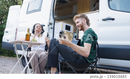 Couple enjoying remote camping life playing guitar 139018885