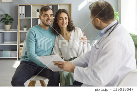 Gynecologist Consulting Happy Couple In Hospital Gynecologist Consulting Happy Couple In Hospital 139019047