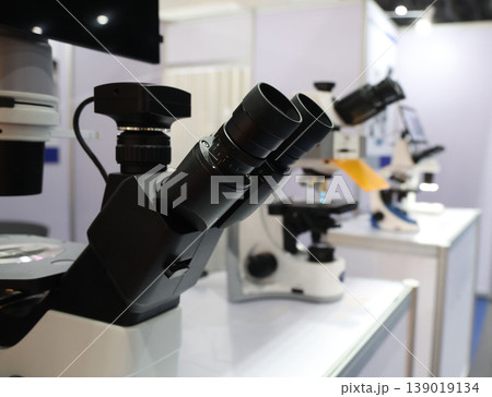 Microscope. Advanced microscopes and digital imaging systems analyzing samples in a modern laboratory. Ideal for medical research microbiology diagnostics biotechnology and science innovation concept Microscope. Advanced microscopes and digital imaging systems analyzing samples in a modern laboratory. Ideal for medical research microbiology diagnostics biotechnology and science innovation concept 139019134