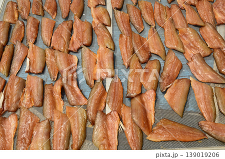 The surface or background of sun-dried striped snakehead fish has a salty taste, which is a type of food preservation used in Asia. The surface or background of sun-dried striped snakehead fish has a salty taste, which is a type of food preservation used in Asia. 139019206