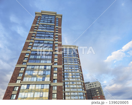 Tall building rises against bright blue sky Tall building rises against bright blue sky 139020005