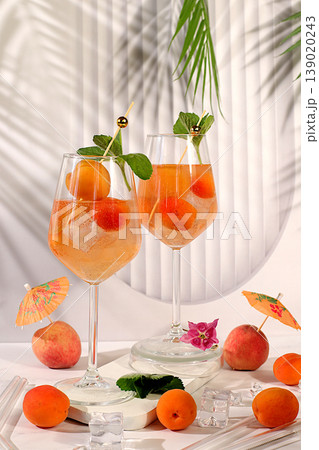 Royal lemonade cocktail with peach, apricot, mojito with tequila, gin, rum, vodka, liqueur, lime, ice and fresh mint, bar and party concept, restaurant and cafe advertising card, summer alcoholic 139020243