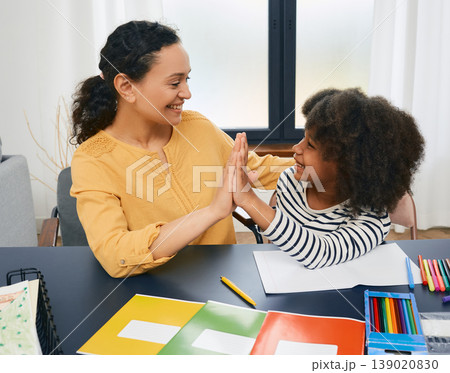 Child psychologist gives five an African American little girl during a psychotherapy session. Care of children's mental health Child psychologist gives five an African American little girl during a psychotherapy session. Care of children's mental health 139020830