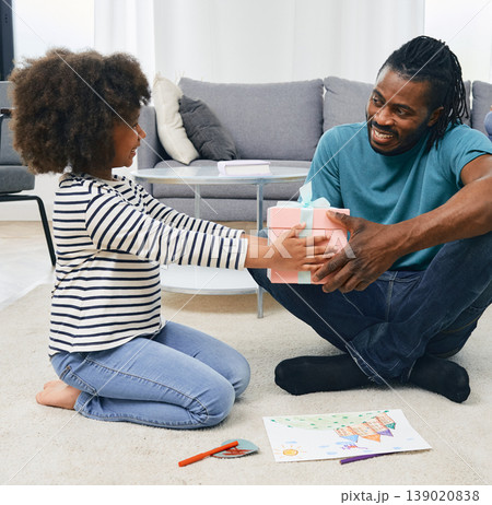 Father's Day. Beautiful little daughter congratulates her father and giving a gift for dad on Father's Day Father's Day. Beautiful little daughter congratulates her father and giving a gift for dad on Father's Day 139020838