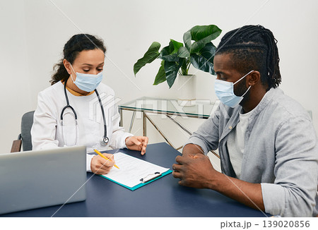 Adult man during visit to general practitioner at medical clinic. Doctor consultation Adult man during visit to general practitioner at medical clinic. Doctor consultation 139020856