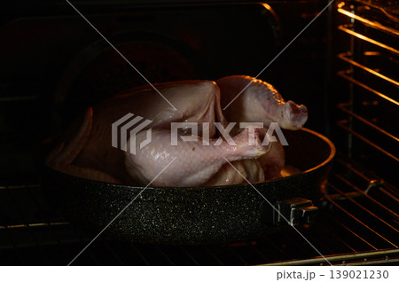 A succulent turkey roasting in the oven, filling the kitchen with delicious arom A succulent turkey roasting in the oven, filling the kitchen with delicious arom 139021230