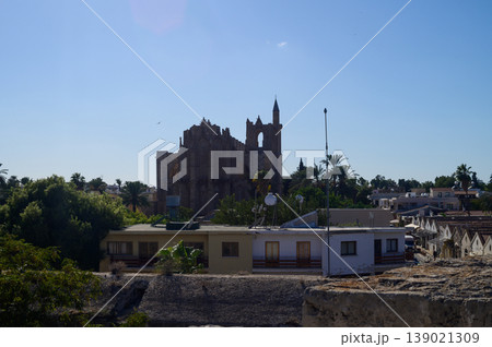 A captivating view of ancient ruins bathed in sunlight near a vibrant village A captivating view of ancient ruins bathed in sunlight near a vibrant village 139021309