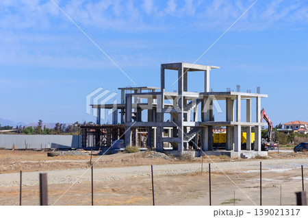 New construction progress on a modern building under clear blue skies in a developing neighborhood New construction progress on a modern building under clear blue skies in a developing neighborhood 139021317