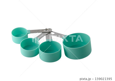 Modern kitchen measuring cups in sage green, complete nesting set isolated on white background Modern kitchen measuring cups in sage green, complete nesting set isolated on white background 139021395