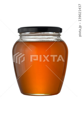 Glass jar with transparent golden honey on white background. Glass jar with transparent golden honey on white background. 139021437