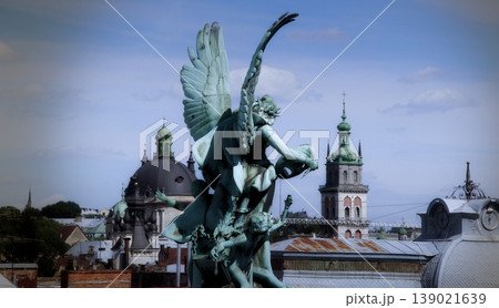 Angels patina sculpture on the roof of old church in historical part of town Angels patina sculpture on the roof of old church in historical part of town 139021639