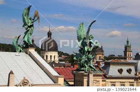 Symbolic patina sculptures over the roofs of the old town of Lviv in Ukraine 139021644