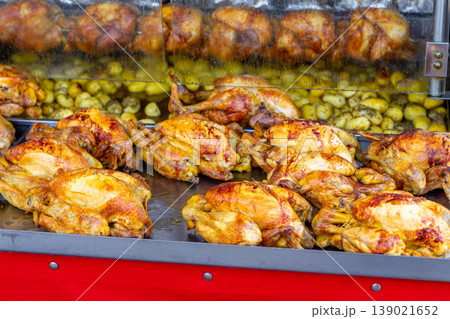 A market stall features an industrial grill oven that cooks whole chickens A market stall features an industrial grill oven that cooks whole chickens 139021652