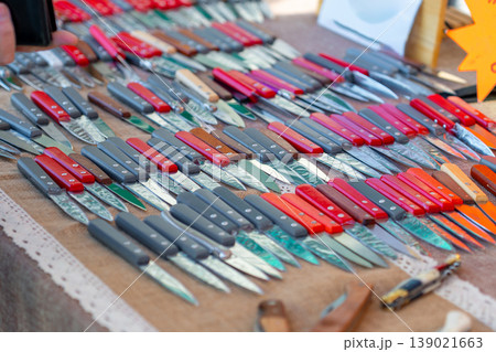 Small handmade pochet knives displayed for sale at the market 139021663