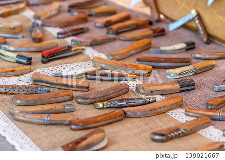 Small handmade pochet knives displayed for sale at the market 139021667