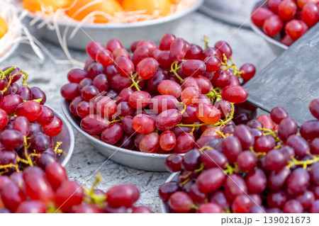 Red grapes on aluminum plates for sale at a market stall 139021673