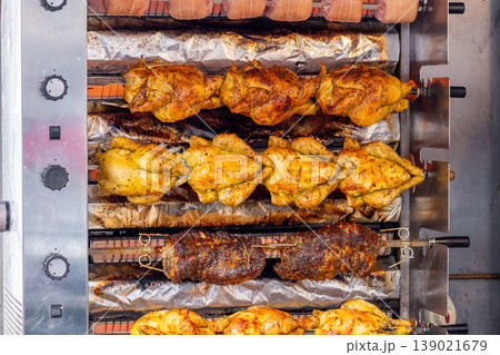 A market stall features an industrial grill oven that cooks whole chickens A market stall features an industrial grill oven that cooks whole chickens 139021679