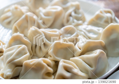 A plate of Georgian khinkali dumplings, Georgian dumplings served on a white plate A plate of Georgian khinkali dumplings, Georgian dumplings served on a white plate 139021690