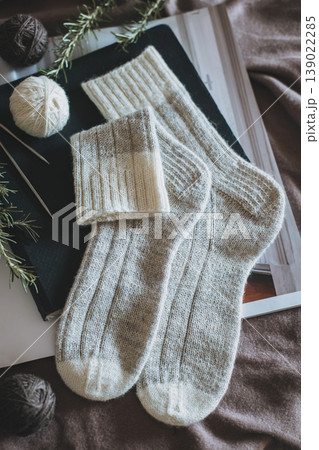 Hand knitted socks with needles and yarn ball. Concept for handmade and hygge slow life. Hand knitted socks with needles and yarn ball. Concept for handmade and hygge slow life. 139022285
